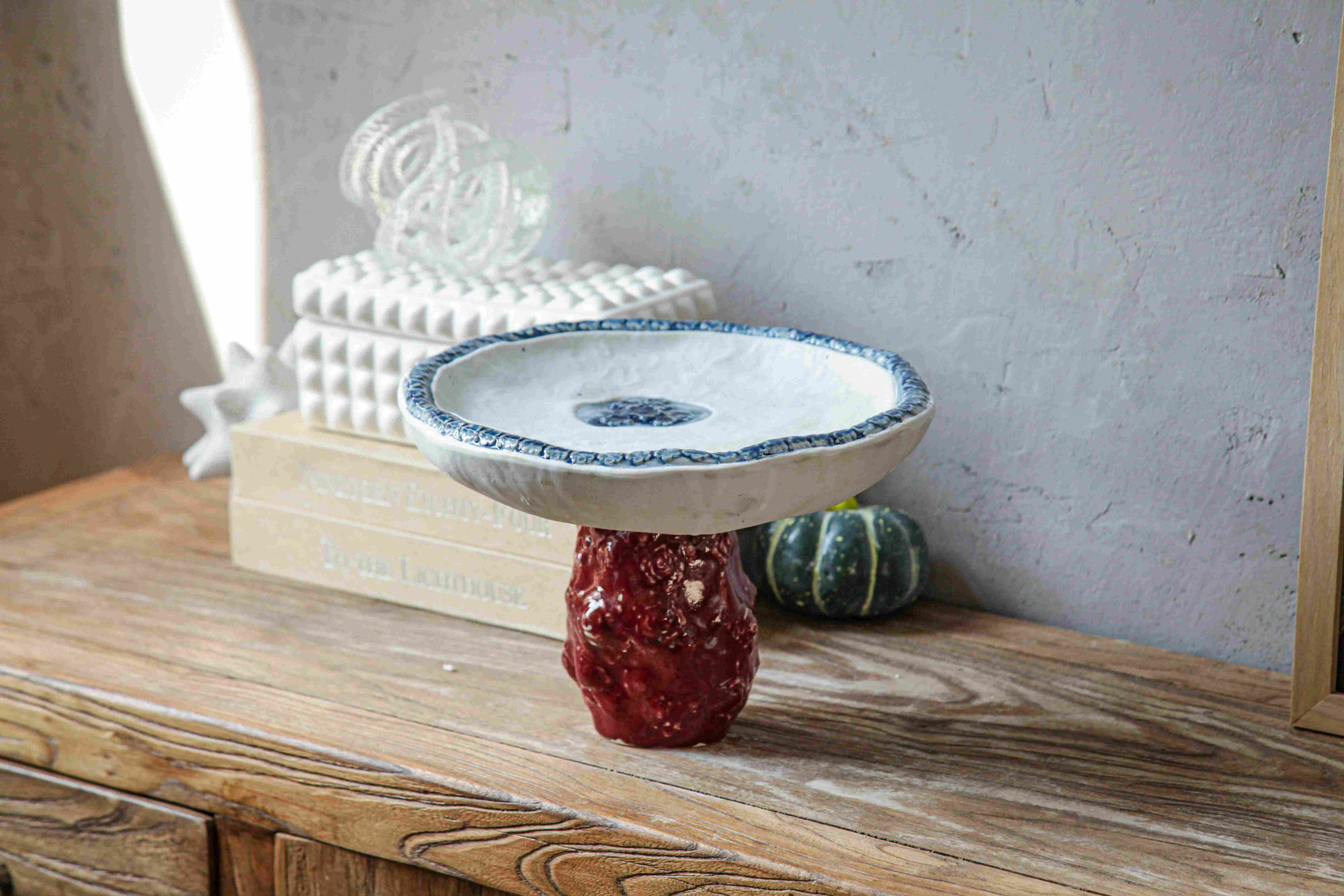 White Bowl on Burgundy Stand